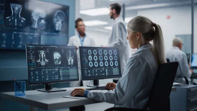 Hero image of a radiologist working on scans